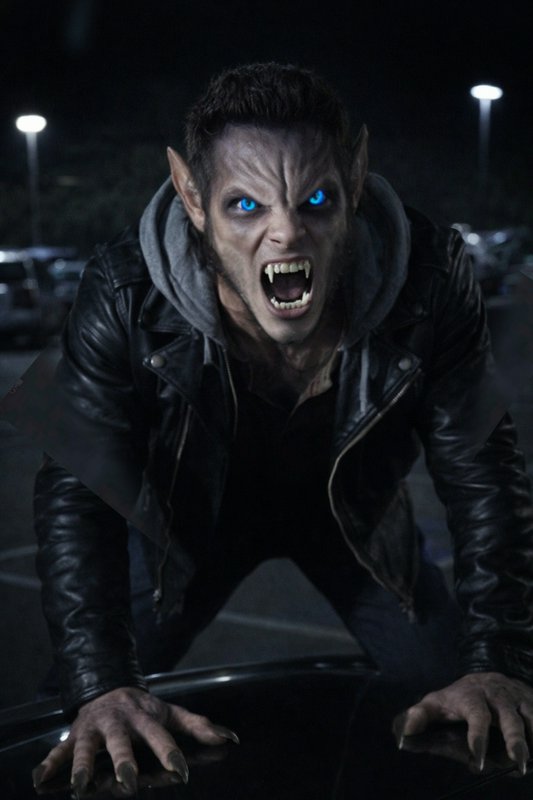 Angry werewolf with blue eyes snarling over a car hood at night in a parking lot.