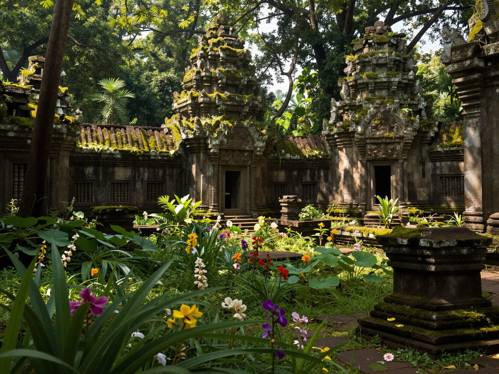 Ancient moss-covered temple ruins in a tropical garden with colorful flowers and stone towers