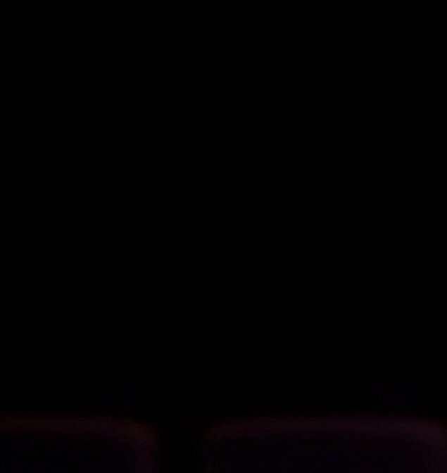 Almost entirely solid pitch black frame with faint, blurred dark purple tones visible only along ...