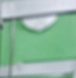 Blurred abstract close-up of a light green panel with white framing and a curved semicircular cutout detail