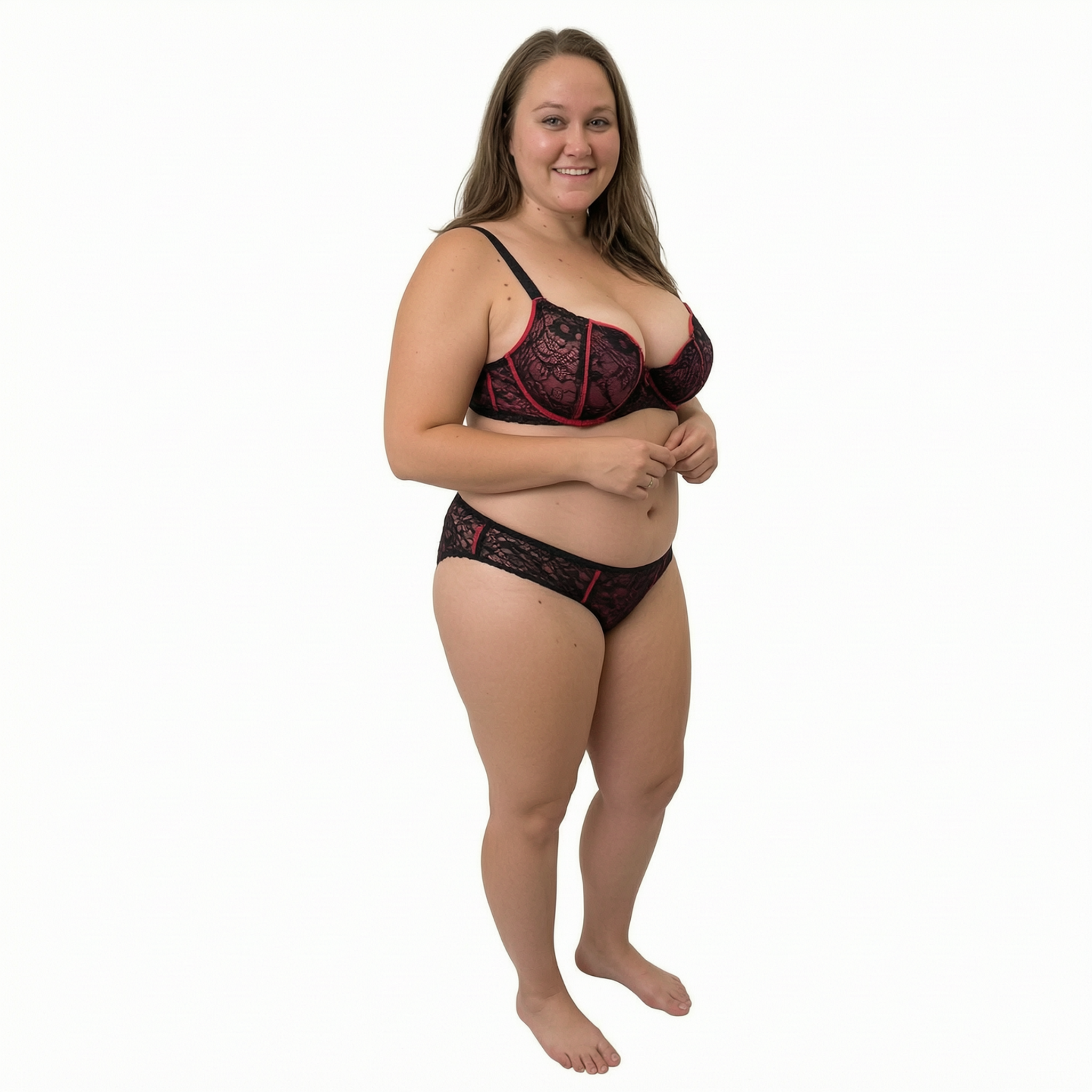 Smiling curvy plus-size woman wearing black and red lace lingerie against a plain white studio background
