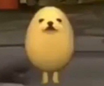 Blurry screenshot of the viral Eggdog meme, a round pale yellow egg-shaped dog character standing...