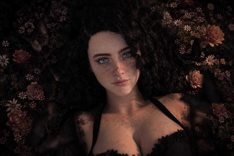 Close-up portrait of freckled blue-eyed woman with curly dark hair lying among wildflowers and dr...