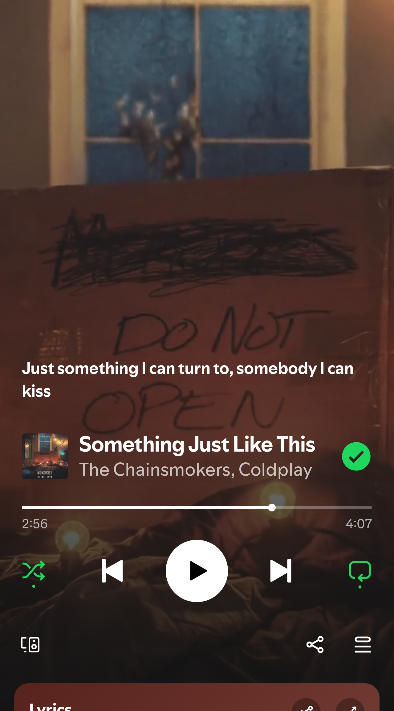 Cardboard sign reading "DO NOT OPEN" with a Spotify screen showing "Something Just Like This" by The Chainsmokers & Coldplay.