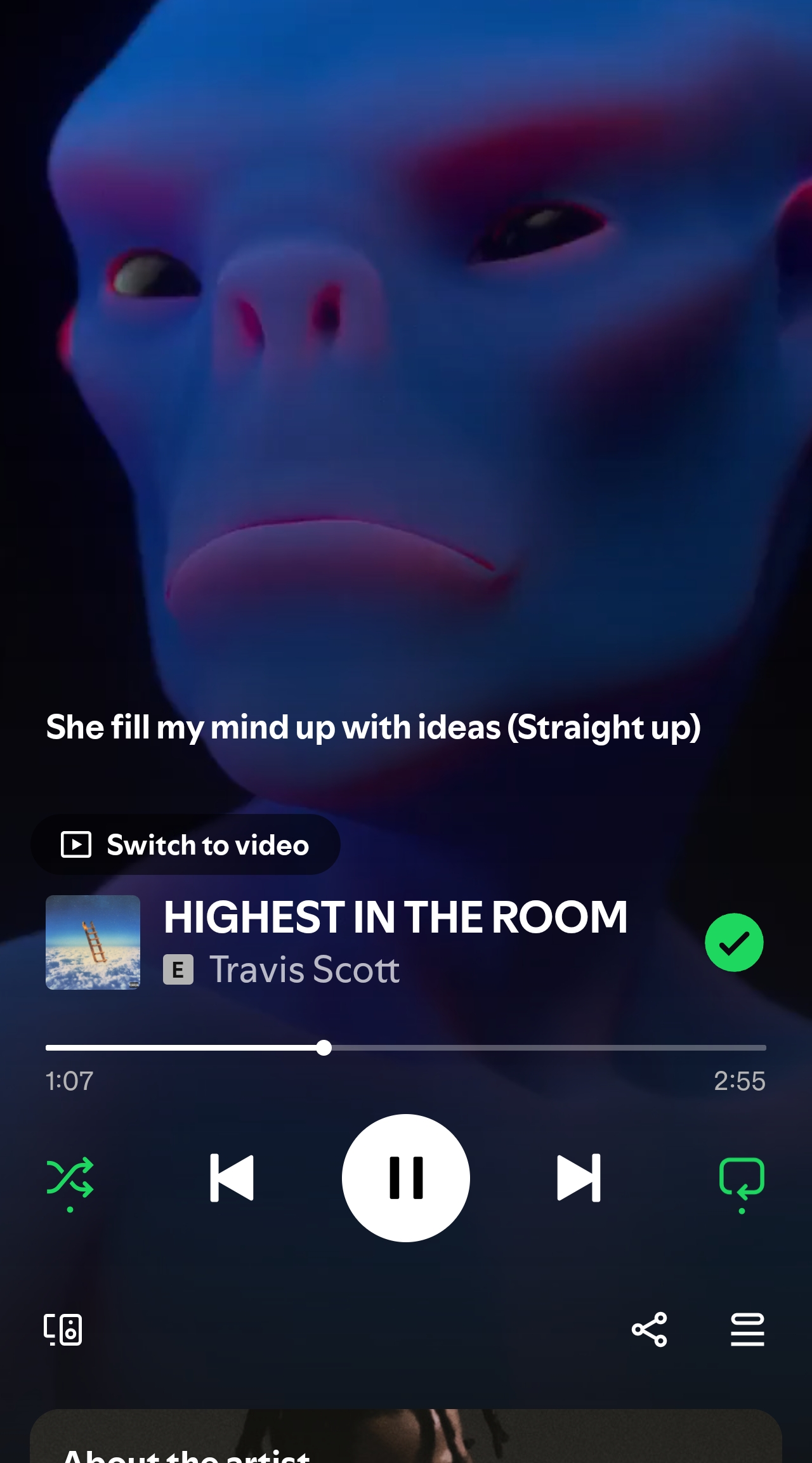 Close-up of a blue, alien-like face in neon lighting with a music player overlay.