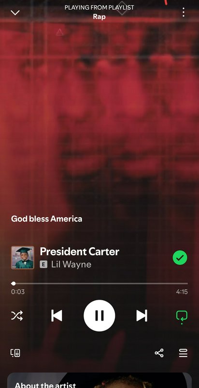 Mobile music player screen playing “God Bless America” by President Carter featuring Lil Wayne.