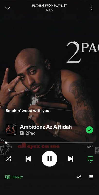 Close-up of a tattooed male rapper posing in a dark music streaming app screen.