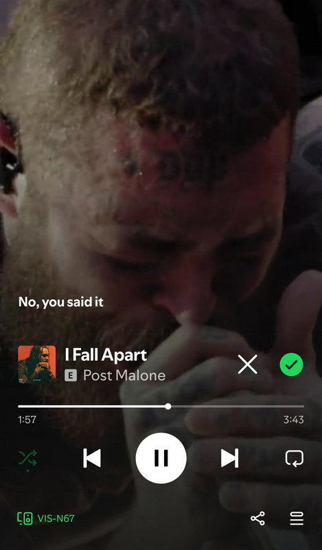 Mobile music player screenshot displaying Post Malone's "I Fall Apart" track over a blurred close...