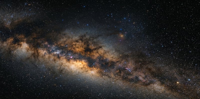 Wide view of the Milky Way galaxy's dusty central bulge and star-filled disk.