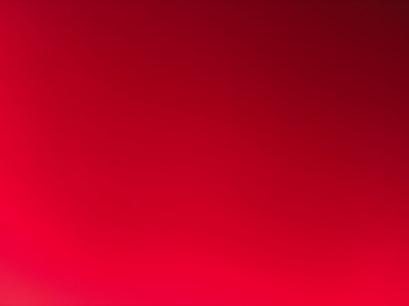 Smooth red gradient background with a warm, vibrant hue and soft darker corners