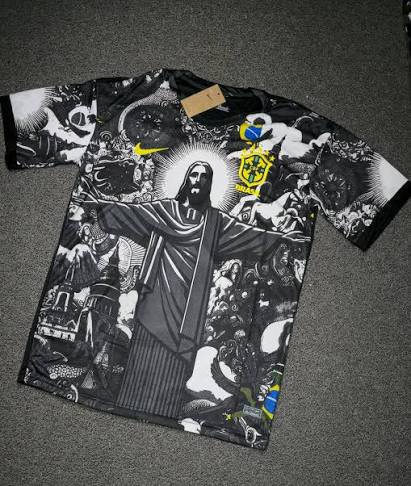 Black and white graphic soccer jersey featuring Jesus Christ with yellow Nike swoosh and Brazil c...