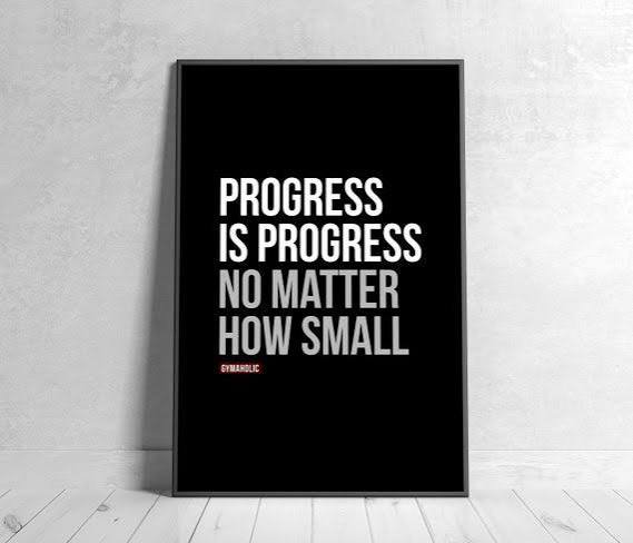 Framed black poster with white typography: "Progress is progress no matter how small" leaning aga...