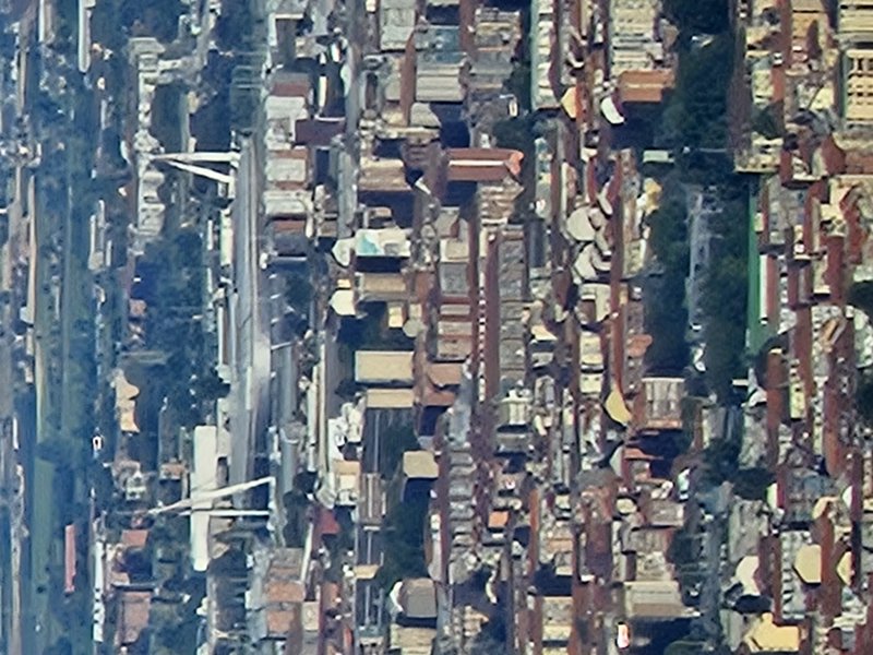Dense cemetery with numerous tombstones and mausoleums in tightly packed rows